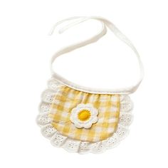 a small yellow and white bag with a flower on the front, hanging from a string