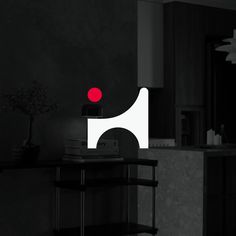 a black and white photo with a red dot on the table in front of it