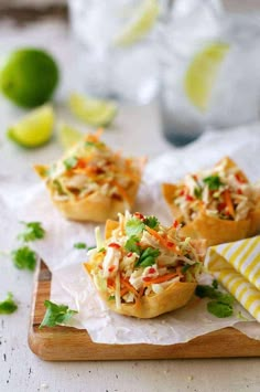 small food items are sitting on top of white paper and garnished with cilantro