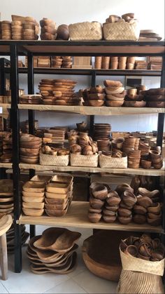 the shelves are filled with many different types of bowls and plates on display in baskets