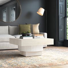 a living room with a couch, coffee table and large mirror on the wall above it