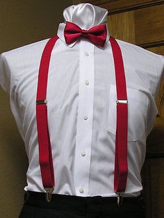 a white shirt with red suspenders and a bow tie