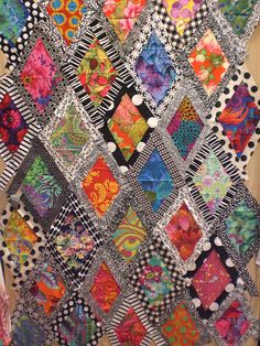 the colorful quilt is made up of many different colors and patterns, including black, white,