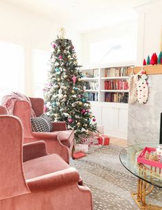 a living room filled with furniture and a christmas tree