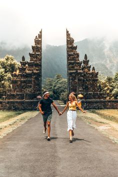 two people walking down a road holding hands