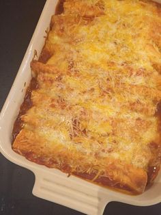 a casserole dish with cheese and sauce in it