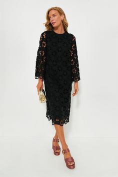 This best-selling silhouette is back in an updated look! The Noir Eyelet Hutton Dress is an elegant style perfect for date nights, dinner parties, and beyond. Featuring unlined floral lace bell sleeves, side slits for ease of movement, and an easy straight silhouette, this look can be styled hundreds of ways. Pair with heels and a clutch or ballet flats and a top-handle bag! Crewneck Long bell sleeves with scalloped edge Back zip closure Straight silhouette Side slits Midi length Lined body, unl Elegant Midi Dress With Cutwork Hem, Spring Evening Dress With Cutwork Hem, Chic Midi Dress With Cutwork Hem, Fitted Evening Dress With Cutwork Hem, Chic Knee-length Midi Dress With Cutwork Hem, Chic Fitted Midi Dress With Cutwork Hem, Elegant Long Sleeve Dress With Cutwork Hem, Party Midi Dress With Cutwork Hem, Long Sleeve Lace Midi Dress For Date Night