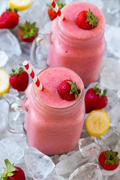 two smoothies with strawberries and lemons on ice