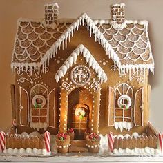 a gingerbread house decorated with icing and candy canes