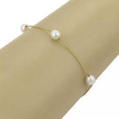 This is an elegant freshwater cultured pearls bracelet from the house of Tiffany & Co. by designer Elsa Peretti from her Pearls by The Yard collection. It has 5 luminious pearls scattered along a delicate 18k yellow gold chain. It is fully signed with Tiffany & Co, Peretti, and the gold content.      Material: 18k yellow gold           Hallmark: T&Co. 750 /   Peretti   Measurements: 7.5" long.    Pearls: 6.5mm long x 6mm wide  Weight: 3.2 grams Formal Fine Jewelry Pearl Bracelet, Elegant Gold Bracelet With Pearl Charm, Formal Yellow Gold Pearl Bracelet With Pearl Chain, Formal Gold Bracelet With Pearl Charm, Formal Yellow Gold Pearl Chain Bracelet, Elegant Yellow Gold Akoya Pearl Bracelet, Formal Yellow Gold Pearl Bracelet With Pearl Drop, Elegant Yellow Gold Pearl Bracelet For Formal Occasions, Formal Yellow Gold Bracelets With Pearl Drop