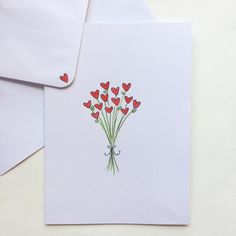 a bouquet of red hearts on a white card