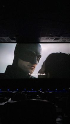 the dark knight rises movie screen with batman and catwoman on it's face