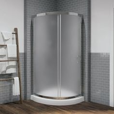 a corner shower stall in a bathroom with wood flooring