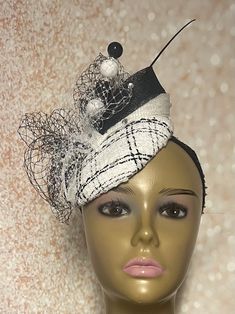 Black and White Tweed Fascinator Half Hat for Church Head Covering, Tea Party, Wedding and Other Special Occasions This black and white hat is trimmed with bows, veiling, rhinestone, a hat pin and black feather stem. The hat pin may vary. Measures approximately 5.9 inches in diameter. Available in 7 and 8 inches. Please DM for assistance. Hat affixes to head by hat string. Handmade Gifts for mom, sister, wife, or yourself. Love what you see, but would like it in a different color, shape or size? Please contact us by sending a message. We offer custom hats in a variety of styles. PLEASE NOTE All items for Free Shipping will be shipped via USPS First Class Mail. Return shipping costs are at the expense of the customer. Black Cloche Fascinator For Party, Chic Fitted Fascinator For Party, Fitted Party Hat With Structured Crown, Fitted Hat With Structured Crown For Party, Elegant Winter Hat With Structured Crown, Chic Fitted Party Headpiece, Chic Fitted Headpieces For Party, Elegant Fitted Mini Hat For Party, Fitted Evening Fascinator Headband