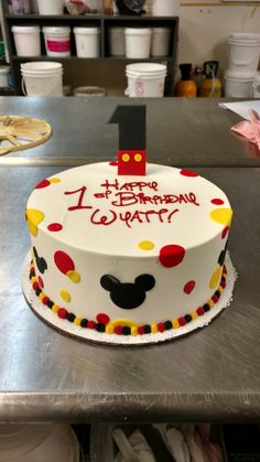 a birthday cake with the number one on it for mickey mouse's 1st birthday