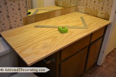 a kitchen counter being constructed in the process of being remodeled with tape and scissors on it