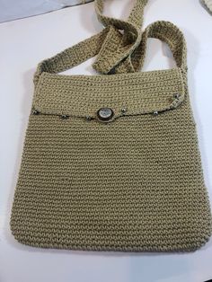 This bag is approximately 10 inches wide and long. There is a small flap with silver embellishments and a decorative button on the front of the purse. Once the flap is open, there is a zipper to keep the contents of the bag safe. Inside is soft nylon lining and a zippered pocket. This vintage bag is like new. It would make a great gift. Rectangular Shoulder Bag With Button Closure, Rectangular Shoulder Bag With Buttons, Beige Crochet Satchel With Large Capacity, Beige Crochet Bag With Adjustable Strap, Beige Crochet Crossbody Bag, Vintage Beige Crochet Bags, Eco-friendly Beige Crochet Crossbody Bag, Vintage Bag, Metal Accents