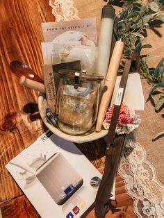 an assortment of items displayed on wooden table with lace doily and flowers in background