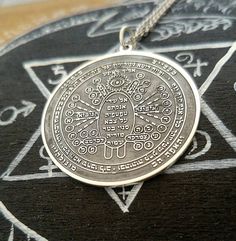 a silver necklace with an intricate design on it