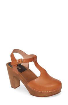 Chic Ankle Strap Clogs With Buckle Closure, Chic Clogs With Ankle Strap And Buckle Closure, Brown T-strap Sandals With Block Heel And Buckle, Leather Closed Toe T-strap Sandals With Stacked Heel, Retro T-strap Heels With Buckle Closure, Leather T-strap Sandals With Stacked Heel And Closed Toe, Leather Clogs With Buckle Closure And Block Heel, Brown T-strap Heels With Buckle Closure, Leather T-strap Sandals With Stacked Heel And Round Toe