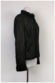 This sophisticated Elie Tahari jacket has all around pleats. Delicate ruffles along the neckline give it a feminine look. Add a fitted LBD dress and red pumps for a polished night time ensemble. Size L 100% silk Button down front All over pleats Long sleeve Embroidered along sleeve cuffs, front, mock pockets & hem Ruffles along neckline Mock pockets Lined Bust 39" Waist 34.5" Shoulder to hem 23.75" Chic Evening Blazer With Ruffles, Spring Formal Outerwear With Ruffles, Spring Formal Ruffled Outerwear, Spring Party Blazer With Ruffles, Elegant Tailored Pleated Blazer, Fitted Pleated Formal Blazer, Elegant Fitted Pleated Blazer, Fitted Pleated Blazer For Formal Occasions, Formal Fitted Pleated Blazer