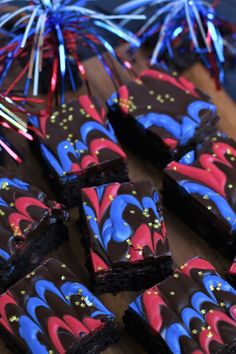 some brownies with red, white and blue frosting on top of a wooden table