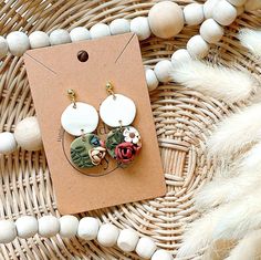 a pair of earrings sitting on top of a table