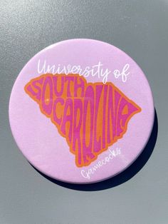 the university of south carolina logo is shown on a purple and orange button that reads, university of south carolina