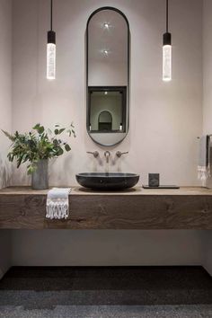 a bathroom with a sink, mirror and lights