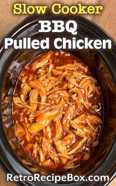 slow cooker bbq pulled chicken recipe in a crock pot on a wooden table