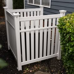 a small white fence in front of a house