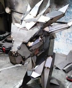 a metal horse sculpture sitting on top of a table next to other tools and materials