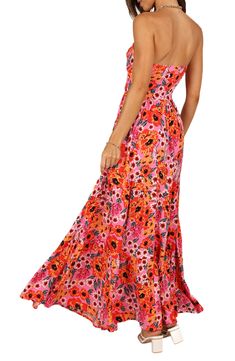 Flirty cutouts at the bodice add to the summery vibes of this strapless maxi dress covered in a vibrant floral print. Hidden side-zip closure Sweetheart neck Strapless Partially lined 100% rayon Hand wash, dry flat Imported Spring Tropical Strapless Maxi Dress, Summer Beach Strapless Dress With Floral Print, Strapless Floral Print Sundress, Feminine Strapless Floral Print Maxi Dress, Strapless Pink Floral Print Maxi Dress, Cutout Maxi Dress, Strapless Maxi, Strapless Maxi Dress, Pink Maxi Dress