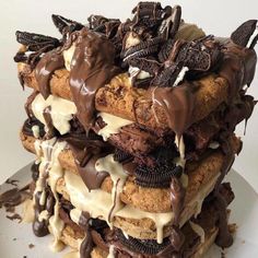 a stack of cookies and oreo cookies on top of each other with chocolate drizzle