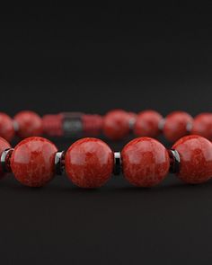 Experience the powerful energy and bold elegance of the Red Coral Jade Bracelet from the Prayer Collection. This stunning piece combines the vibrant red hues of coral jade with a sophisticated design, making it a standout accessory for any occasion. Design and Materials: Red Coral Jade Beads: Featuring smooth 8mm red coral jade beads, this bracelet embodies the striking red tones known for their energizing and protective properties. Gold Plated Cylindrical Spacers: Each jade bead is separated by Red Jade Bracelet, Red Jade, Stacked Necklaces, Red Tigers Eye, Jade Bracelet, Recycled Silver, Black Rhodium, Jade Beads, Mens Essentials