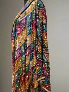 Experience the beauty of traditional Phulkari style with our Multicolor Dupatta. Made with a soft and luxurious silk finish, this dupatta features real mirror accents and stunning designs. Its heavy-weight construction makes it perfect for special occasions like Navaratri. Elevate your wardrobe with this must-have accessory. Approx 2.5 meters length Luxury Multicolor Dupatta For Puja, Luxury Bandhani Print Dupatta For Puja, Luxury Jamawar Traditional Wear With Zari Weaving, Luxury Multicolor Handloom Dupatta, Multicolor Semi-stitched Jamawar Dupatta, Unstitched Multicolor Motif Sharara, Unstitched Multicolor Sharara With Motifs, Multicolor Dola Silk Traditional Wear With Resham Embroidery, Bohemian Shawl With Zari Work For Festive Season