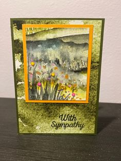 a card with an image of flowers and the words, with sympathy written on it