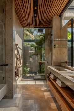 a large bathroom with a wooden ceiling and two sinks in the center, along with a walk - in shower