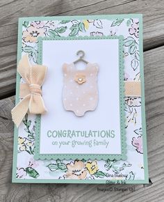 congratulations card featuring a baby's bib and a bow