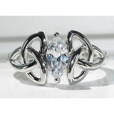 a white gold ring with an oval cut diamond in the center and two intertwined bands around it