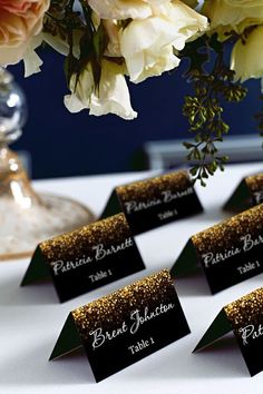 place cards are placed on a table with flowers