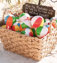 a basket full of beach balls with a sign saying when the northwests walk your way has the beach ball and shoot honey