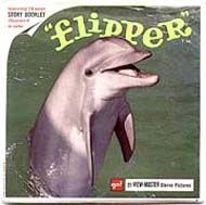 an advertisement for flipper featuring a dolphin in the water with it's mouth open