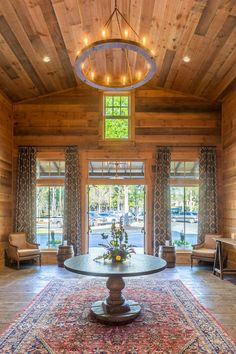 the inside of a house with wood paneling and chandelier