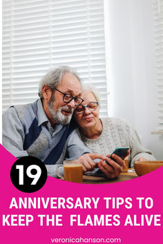 an older man and woman looking at a cell phone with the caption 19 anniversary tips to keep the flames alive