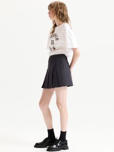 This mini length skirt has detachable pleated panel at front, providing unique and casual style. Without the pleated panel, it turns into minimalistic, semi A-line silhouette.  - Slim fitting, mini length design- Detachable pleated panel for added volume- Adjustable button strap at waist- Casual side pockets- Back zip fastenings Workwear Mini Pleated Skirt With Pleated Hem, Workwear Pleated Mini Skirt, Relaxed Mini Skirt With Pleated Hem, Short Length Mini Skirt With Accordion Pleats, Classic Mini Skort With Pleated Skirt, Mini Skirt With Accordion Pleats, Relaxed Pleated Waist Mini Skort, Relaxed Mini Skort With Pleated Hem, Relaxed Fit Pleated Mini Skort