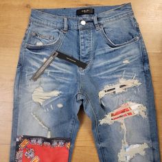 New With Tags Art Patch Ripped Jeans. Amiri Presents These Jeans, Crafted From Light-Washed Denim, Ripped And Repaired With Unique Graphic Patches. This Unique Pair Is Made In La Fabric From Italy. Size 30 Designer Distressed Jeans For Streetwear, Designer Denim Jeans For Streetwear, Luxury Denim Jeans For Streetwear, Amiri Jeans, Patch Jeans, Patched Jeans, Washed Denim, Jeans Color, Tag Art