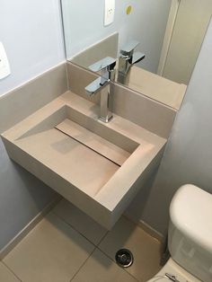 a bathroom with a toilet, sink and mirror