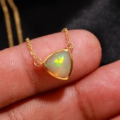 Natural Ethiopian Opal 18k Solid Gold Charm, Opal Pendant Necklace, Handmade Gold Necklace, Opal Gold Necklace, October Birthstone Necklace, Gift For Mom Charm Necklace, Gift For Partywear Necklace, Gift For Her Necklace Gross Wt -  2.80 Grm  Opal Stone Size-   8 mm (Trillion) Chain  -   Link Chain 1 mm Fish Lock Size-   5 mm Chain Length - 16 Inch Total (With 2-inch Adjustable Extension) Stone -   Natural Fire Ethiopian Opal Gemstone # SOLID GOLD CHARM NECKLACE# Handmade = yes Marking      = ye Formal Opal Necklace With 17 Jewels, Luxury Ethiopian Opal Jewelry For Anniversary, Luxury Ethiopian Opal Formal Jewelry, Luxury Opal Necklace With 17 Jewels, Yellow Gold Opal Necklace For Anniversary, Elegant Ethiopian Opal Gemstone Necklaces, Elegant Ethiopian Opal Necklace In Yellow Gold, Luxury Gold Opal Necklaces, Yellow Gold Opal Pendant Necklace