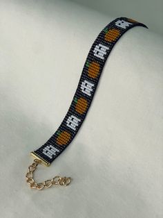 a beaded bracelet with an orange design on it